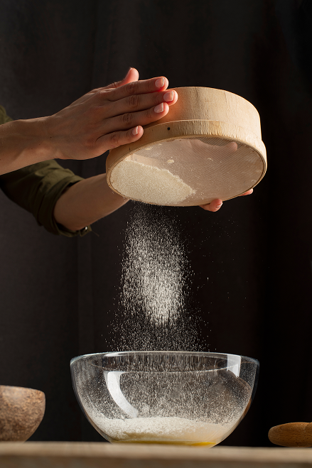 close-up-hands-sifting-flour